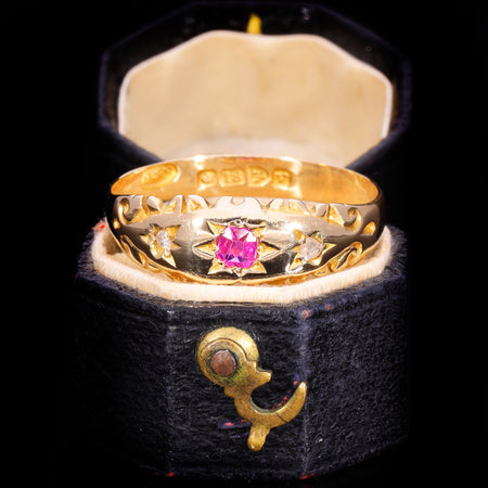 Front view of Edwardian 18ct gold ruby and diamond three-stone ring