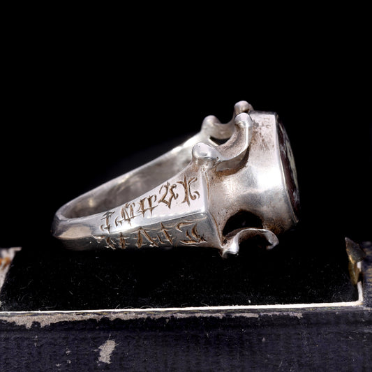 Side view showing engraved initials 'PNS', date '1601', and scrollwork shoulders