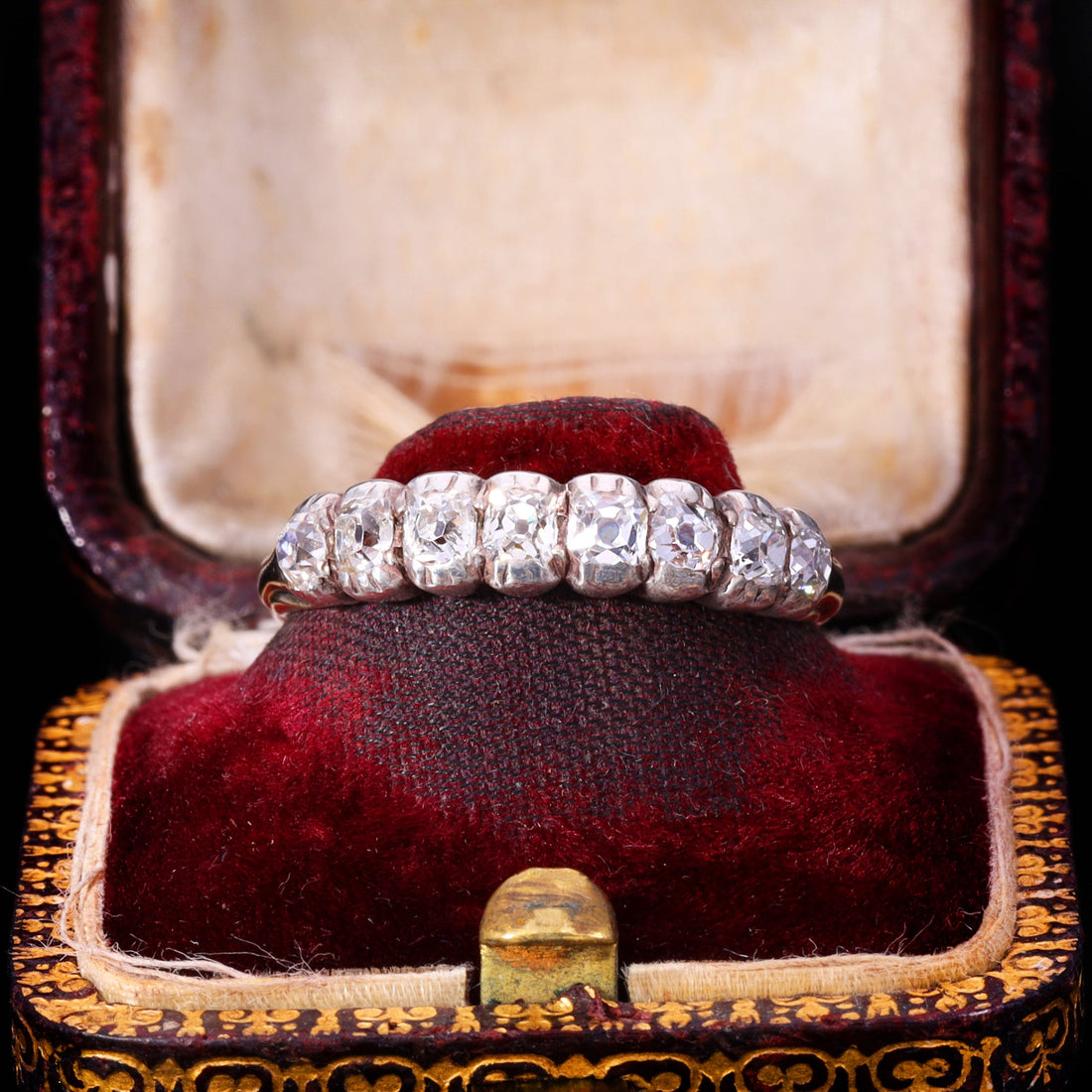 Victorian old mine cut diamond half hoop ring showing eight graduated hand-cut diamonds in individual silver collet settings on an 18ct gold band