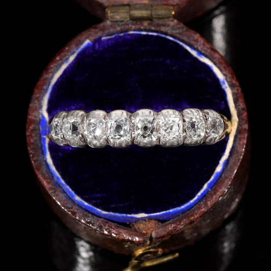 Victorian half hoop ring with five graduated old mine cut diamonds in silver collet settings on an 18ct yellow gold band, displayed in original blue velvet box