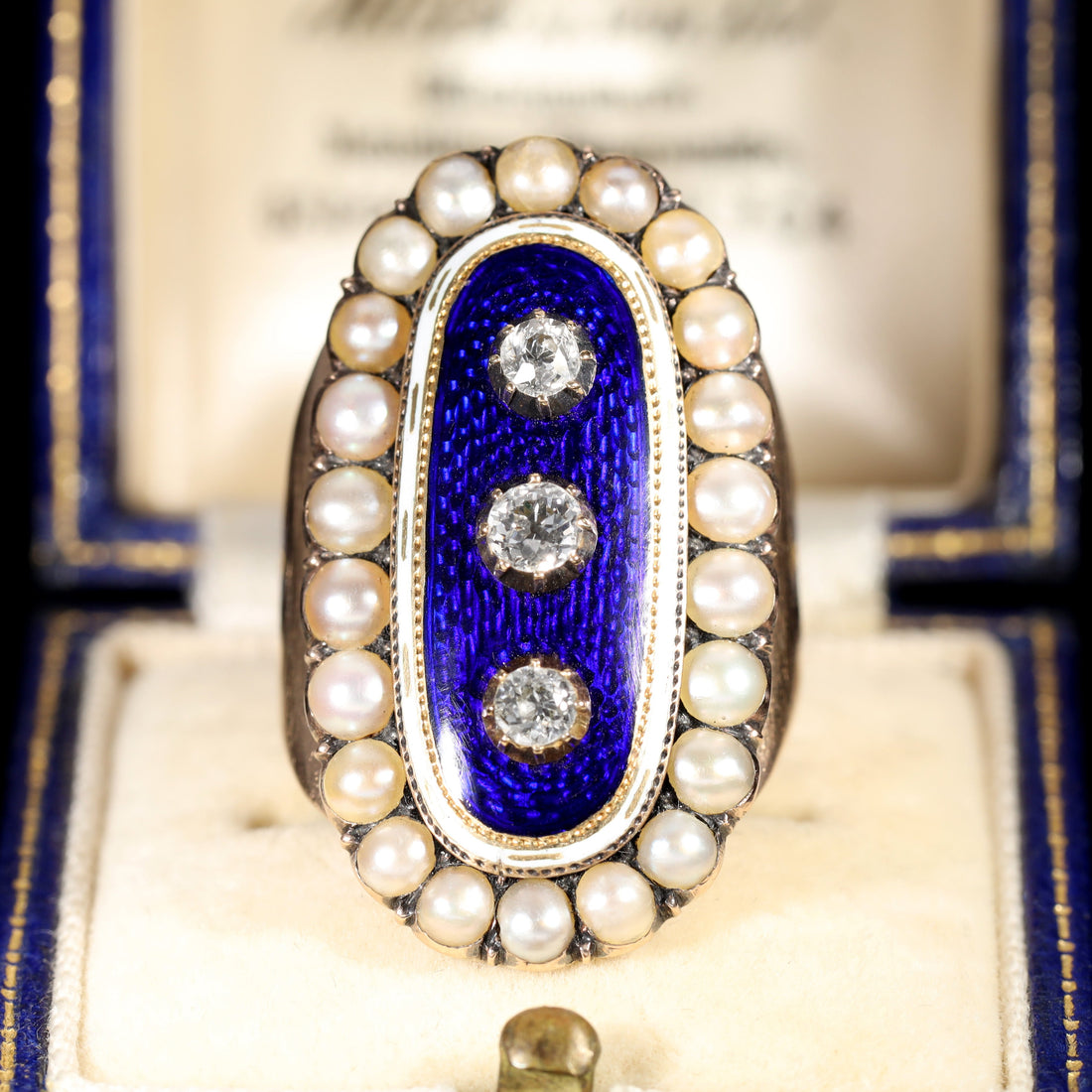 Georgian mourning ring with blue guilloché enamel, three old-cut diamonds, white enamel border, and natural pearl surround, circa 1789
