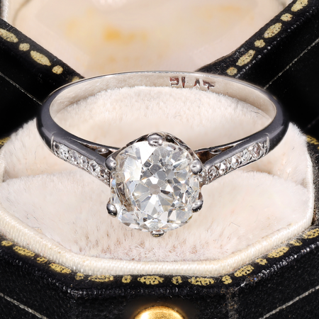 Art Deco era solitaire ring with a large old mine cut diamond in a platinum claw setting, showing the characteristic cushion shape, high crown, and visible culet of the old mine cut