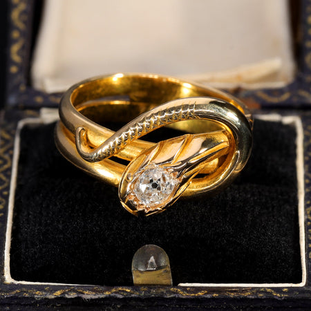 Antique gold coiled snake ring with old cut diamond set in the serpent's head, exemplifying the Victorian serpent ring tradition popularised by Queen Victoria's engagement ring