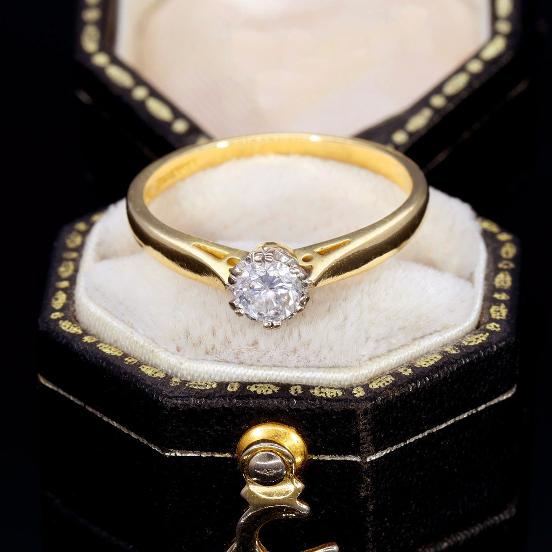Vintage 18ct yellow gold diamond solitaire engagement ring with brilliant cut diamond in a claw setting, displayed in an antique hexagonal ring box