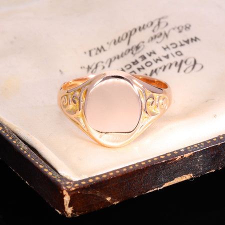 Front view of 1915 9ct rose gold oval signet ring with scrolled shoulders
