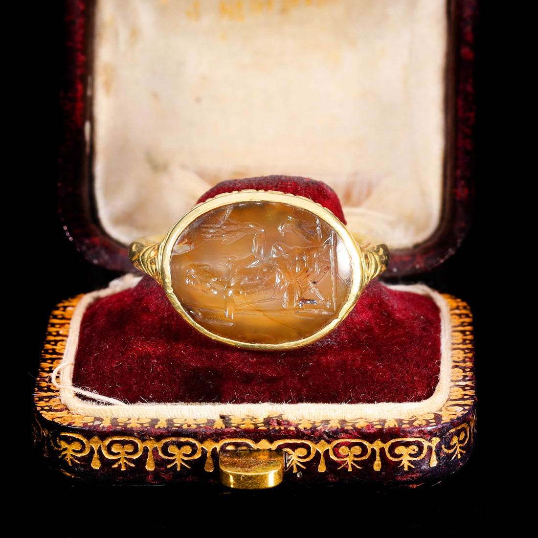 Stuart period gold intaglio ring with Jupiter carved into onyx, circa 17th century, displayed in its original antique box with red velvet lining