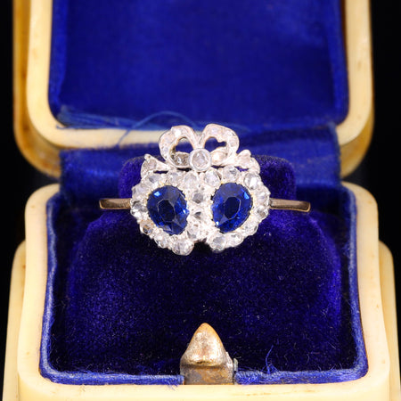 Victorian sapphire and diamond double heart sweetheart ring with bow motif, rose-cut diamonds in silver settings on a yellow gold band