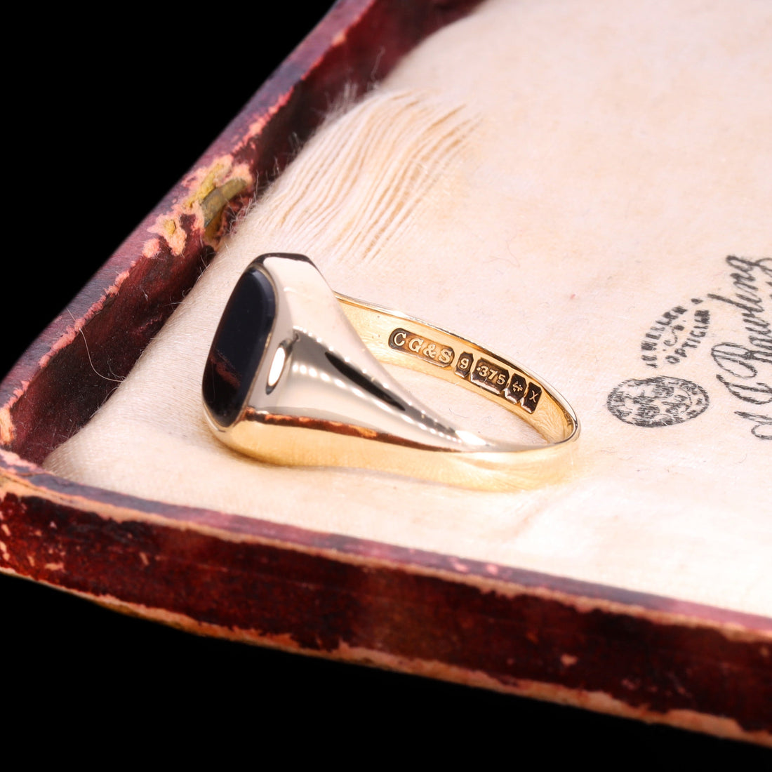 Inner band of a vintage 9ct gold onyx signet ring showing the full Birmingham hallmark set including maker's mark