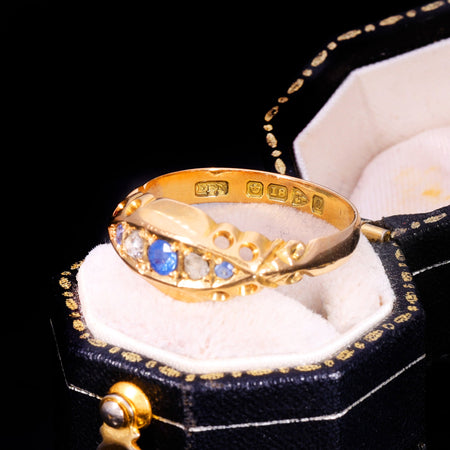 Chester 1915 hallmarks clearly visible inside the band of an 18ct gold sapphire and diamond ring, showing maker's mark, assay office mark, fineness stamp, and date letter