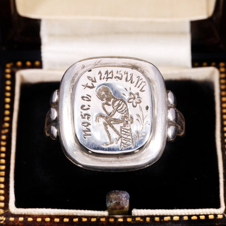 Top view of Georgian silver memento mori signet ring engraved with skeleton and 'Nosse Te Ipsum'