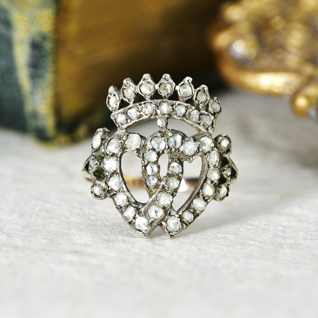 Victorian rose cut diamond Luckenbooth ring in silver and gold, featuring two intertwined hearts beneath a crown, a traditional Scottish design associated with Edinburgh's goldsmiths
