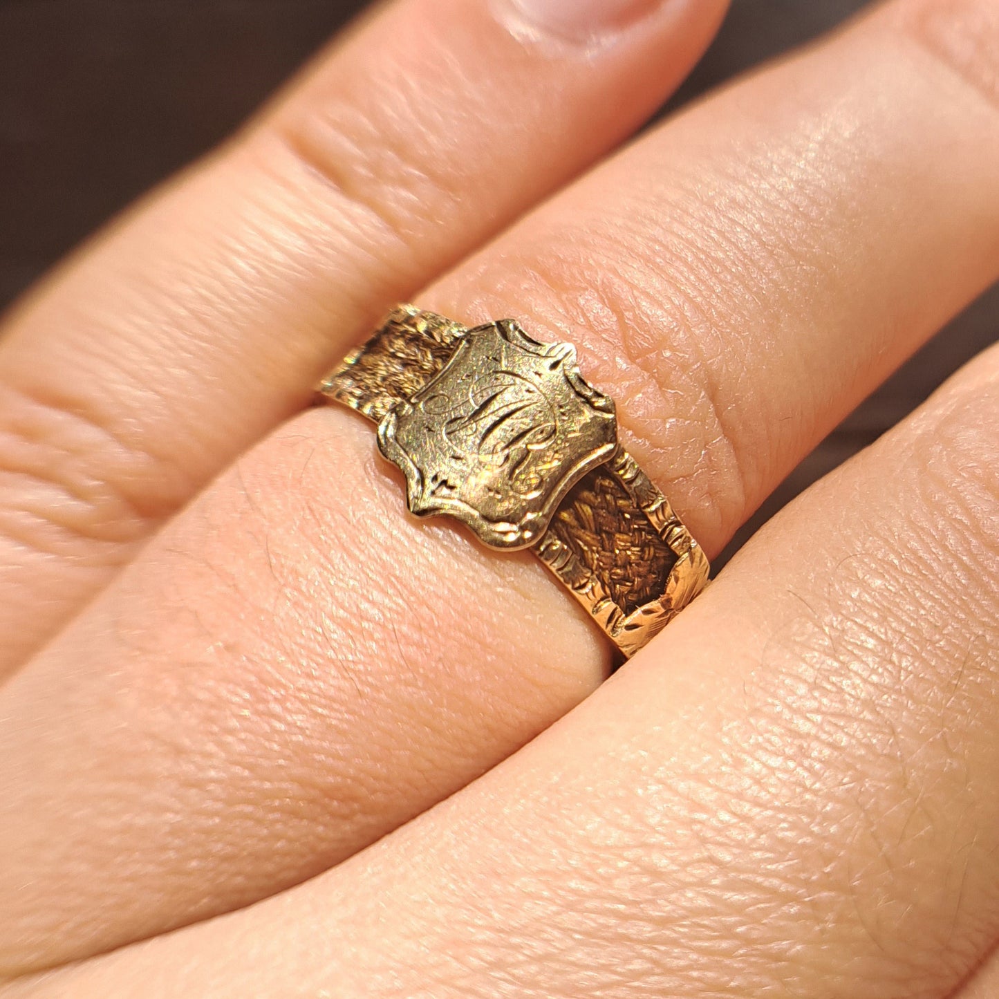 Ring worn on hand showing scale of Victorian hairwork mourning band