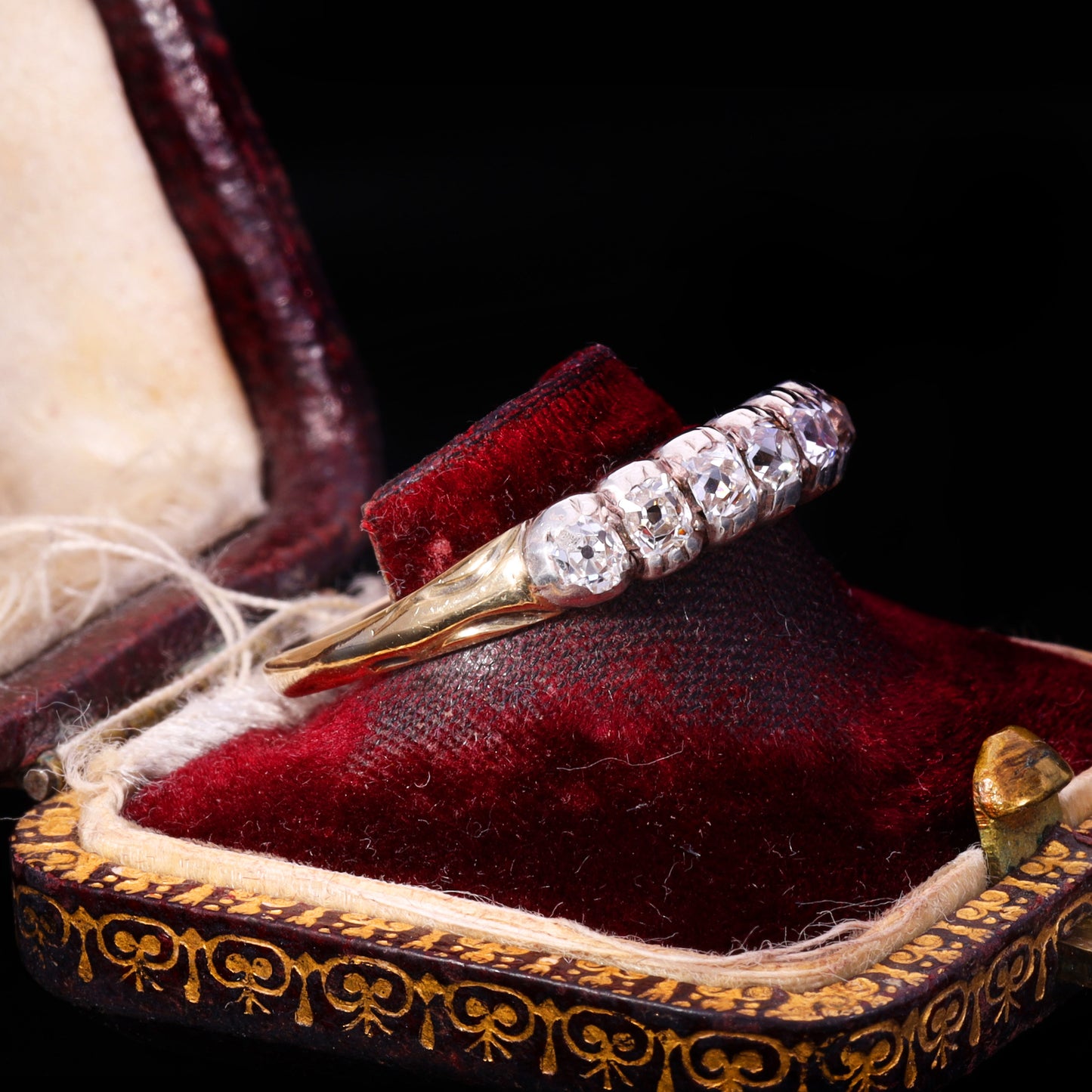 Side view of Victorian old mine-cut diamond half hoop ring in gold and silver