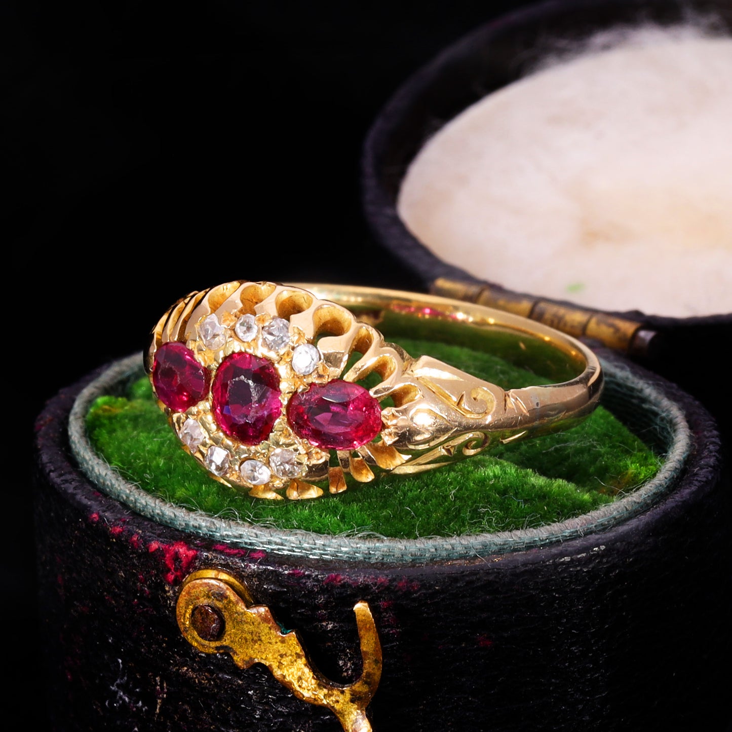 Three-quarter view of Victorian ruby and old cut diamond cluster ring in 18ct gold