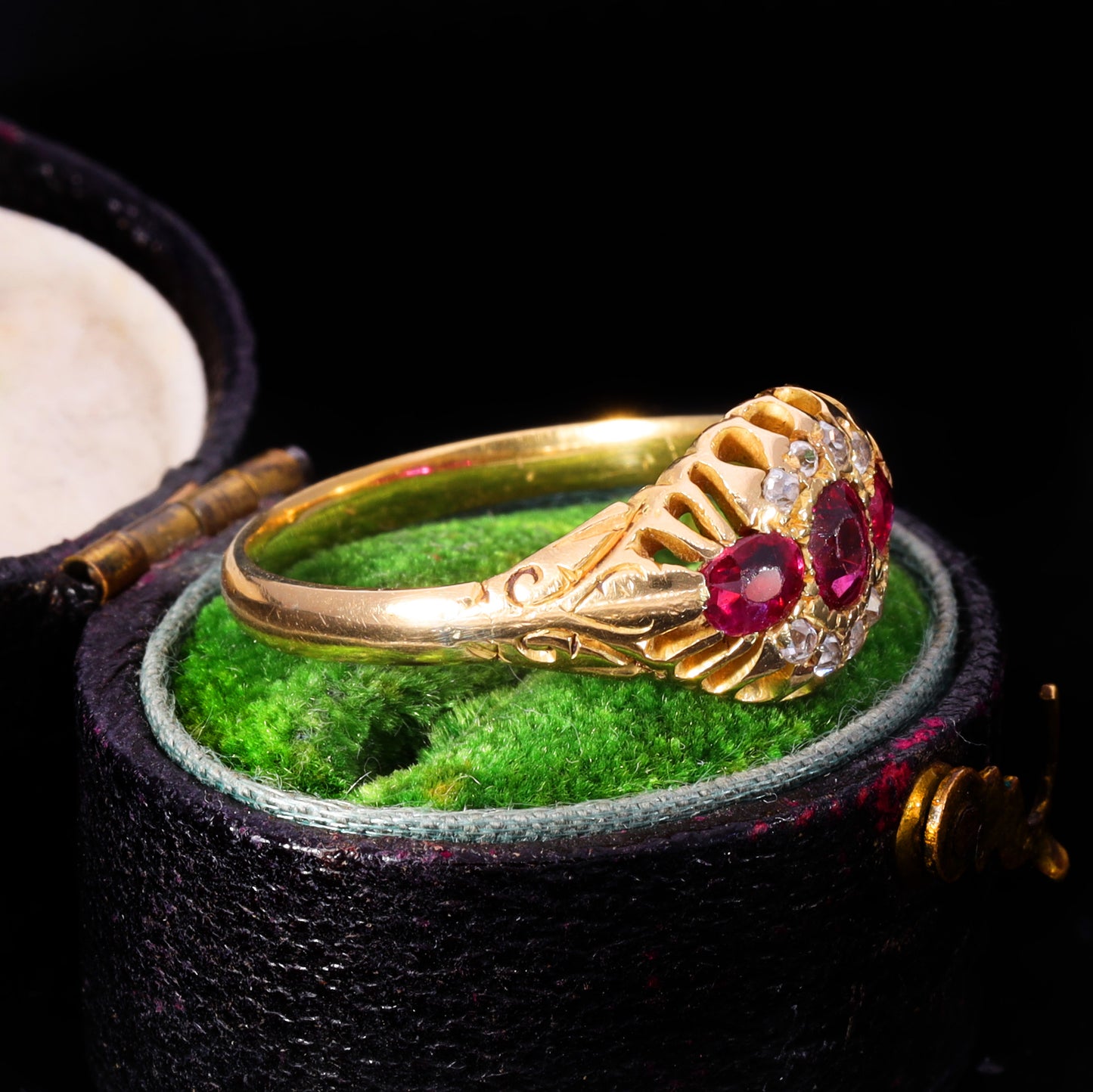 Side profile showing openwork claw setting and scrollwork shoulders, Victorian ruby cluster ring