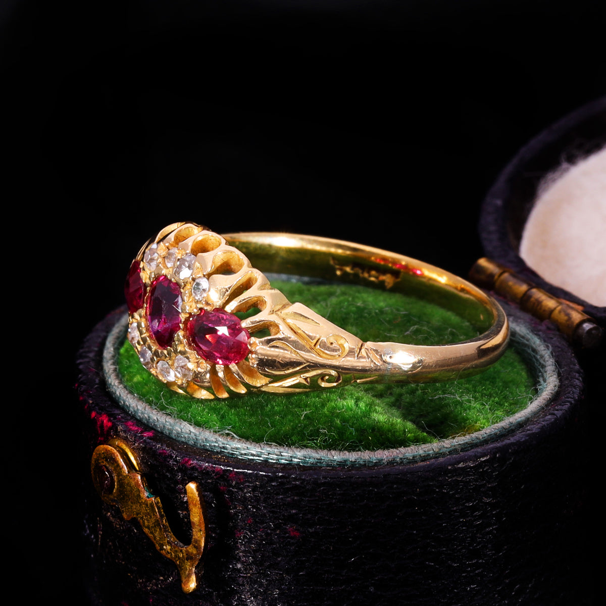 Side profile showing openwork claw setting and scrollwork shoulders in 18ct gold