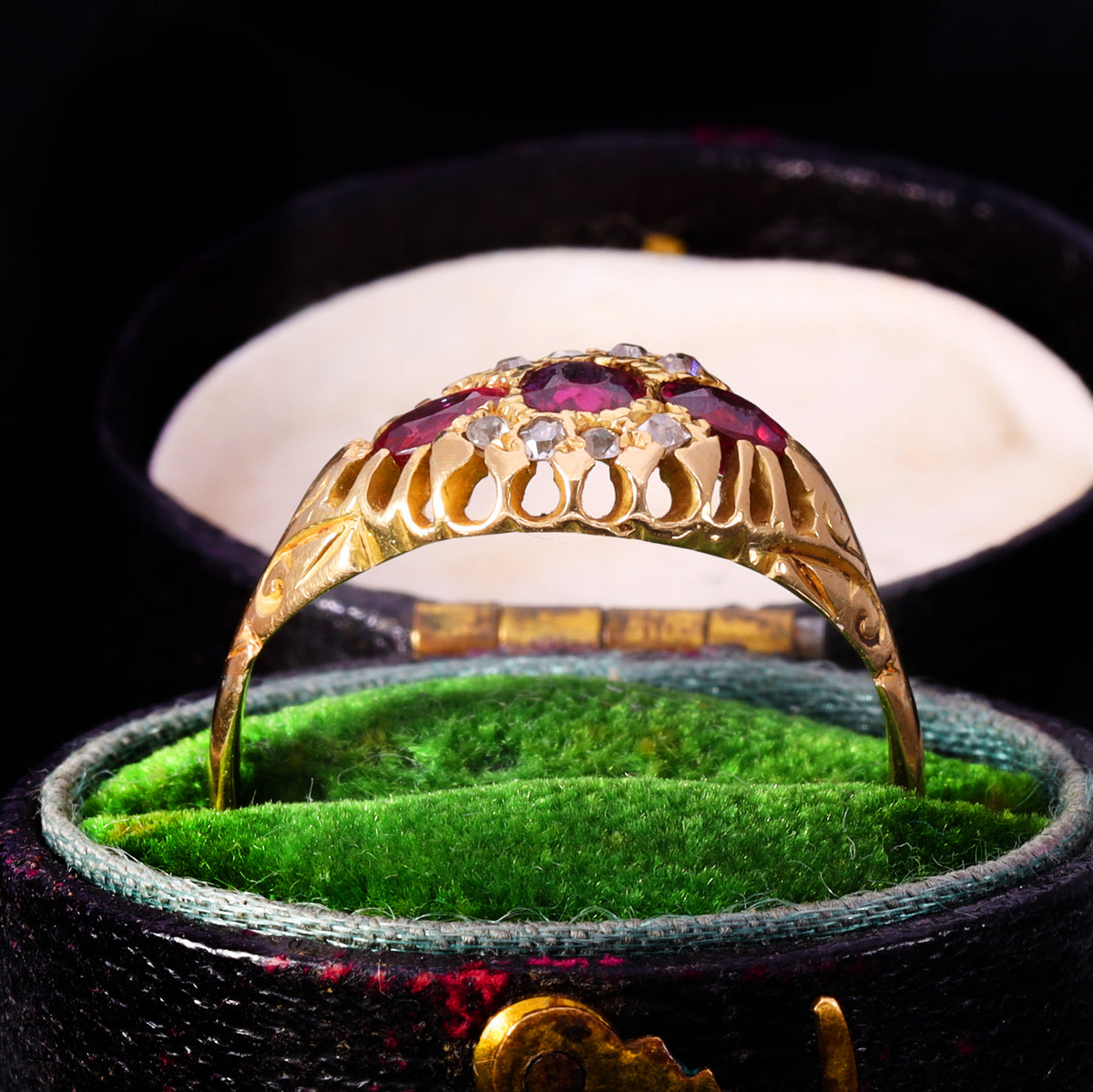 Side profile showing openwork claw gallery and engraved shoulders on Victorian ruby ring