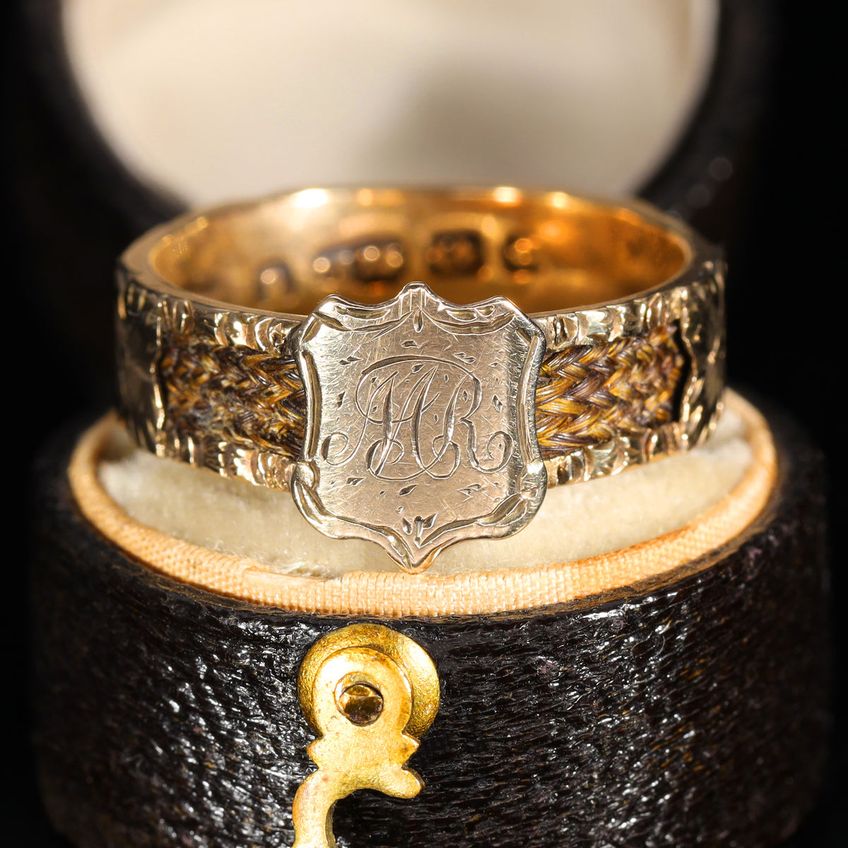 Front view of Victorian 9ct gold mourning ring with engraved 'M.R' shield cartouche