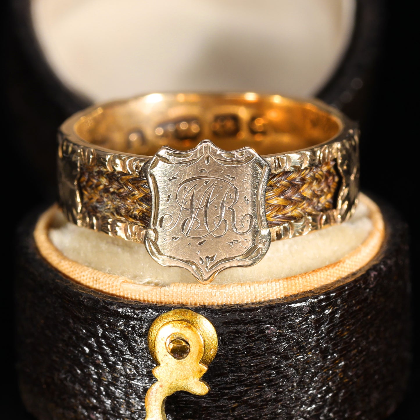 Front view of Victorian 9ct gold mourning ring with engraved 'M.R' shield cartouche