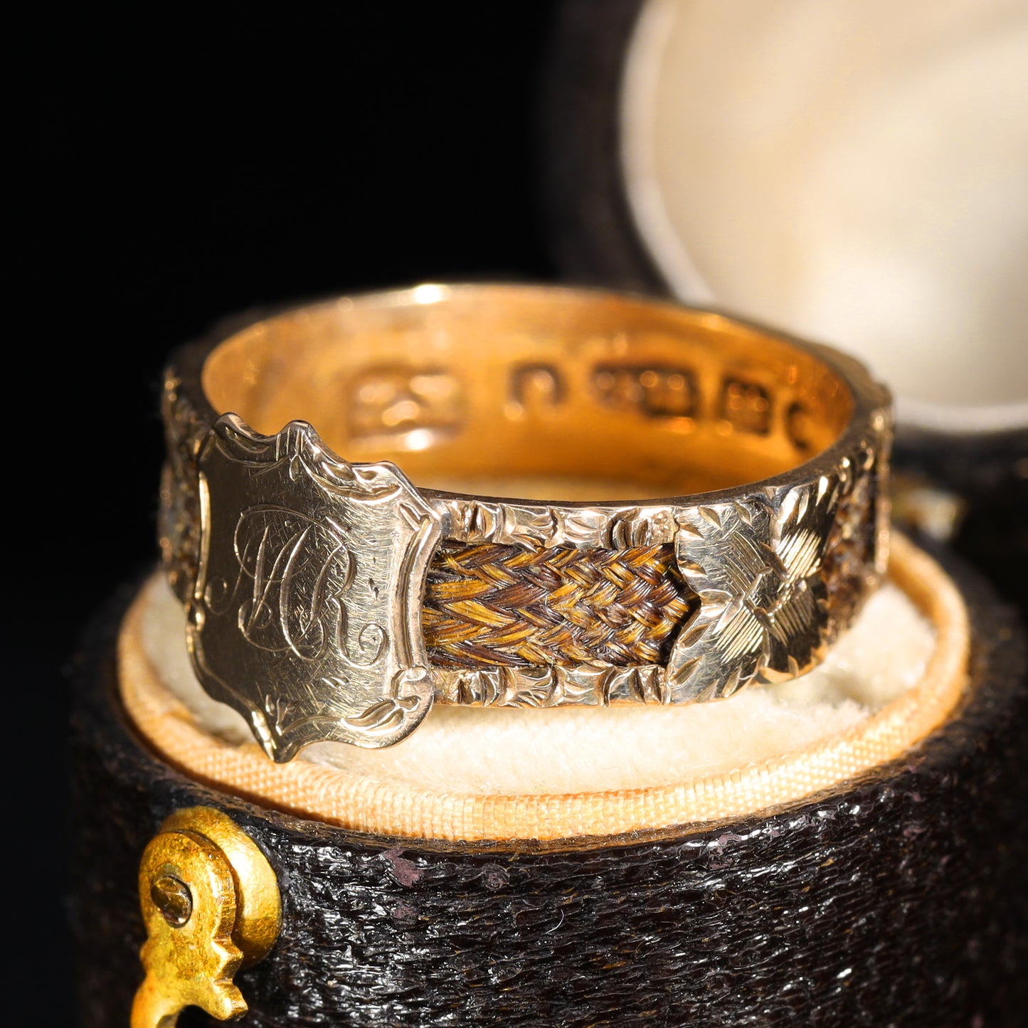 Front view showing 'M.R' shield cartouche and braided hairwork band