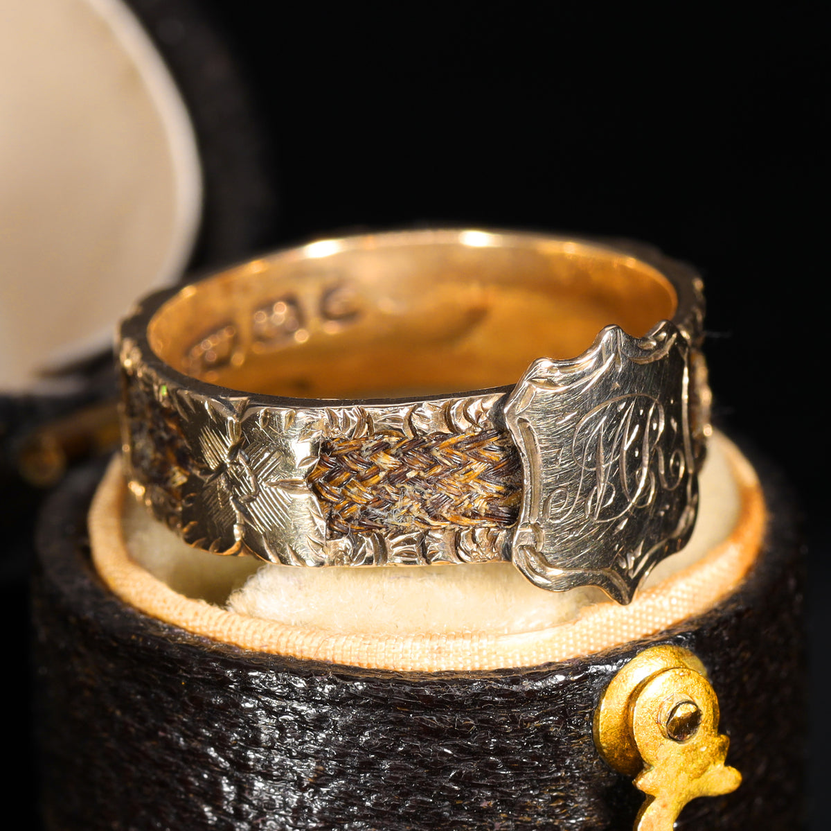 Side view of braided hairwork panel and engraved floral band detail
