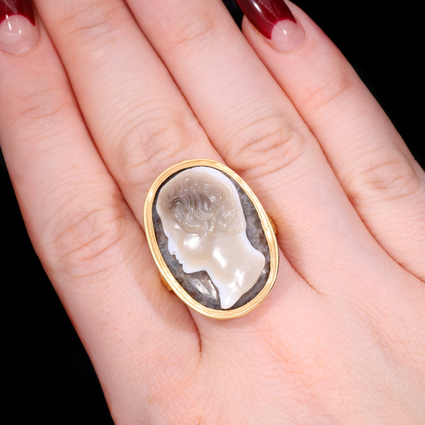 Ring worn on hand showing scale of sardonyx cameo profile carving