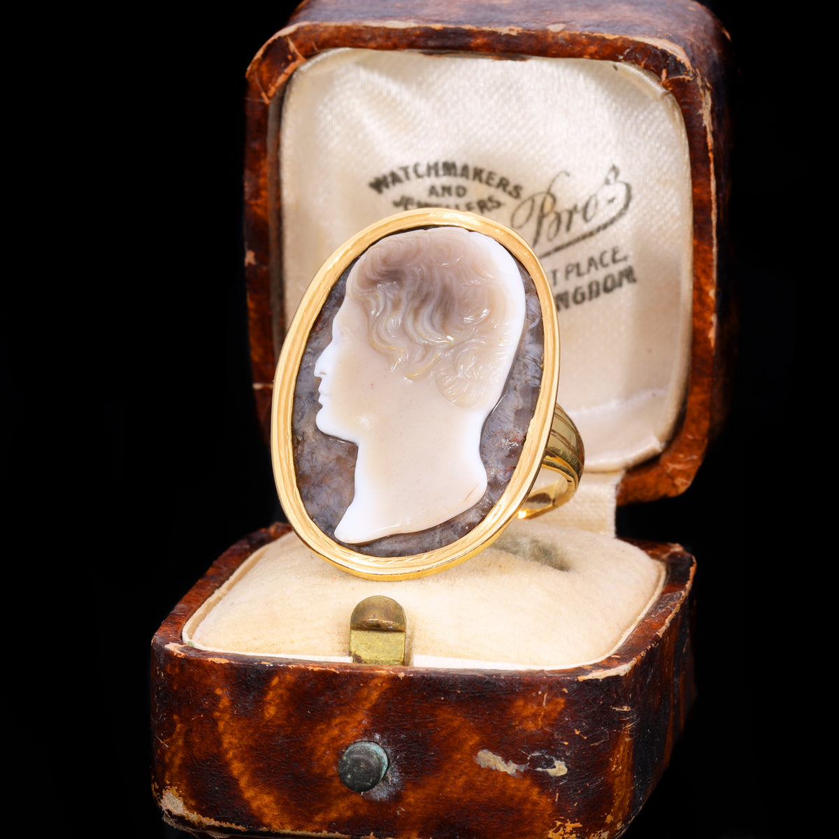 Front view of sardonyx cameo ring depicting profile of young man with wavy hair