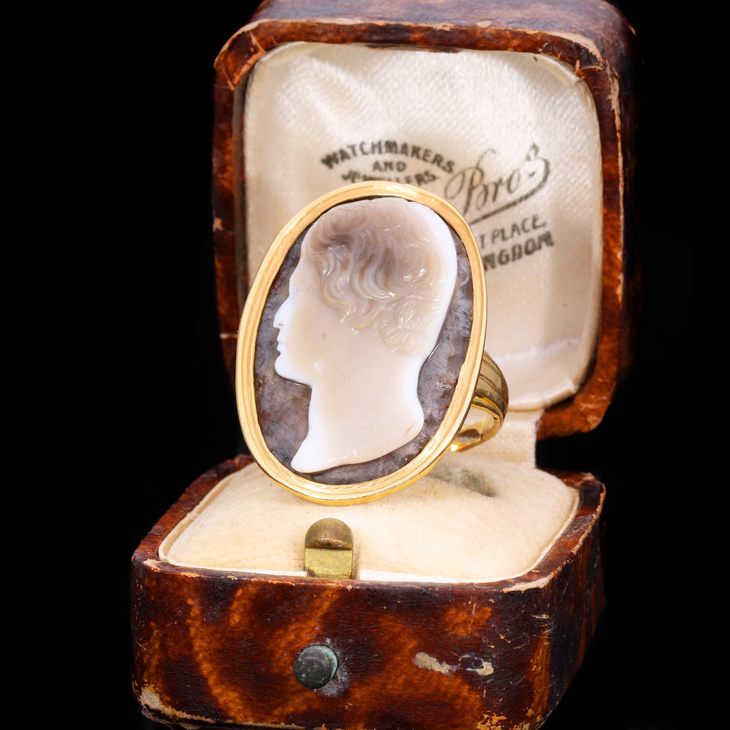 Front view of sardonyx cameo ring depicting profile of young man with wavy hair