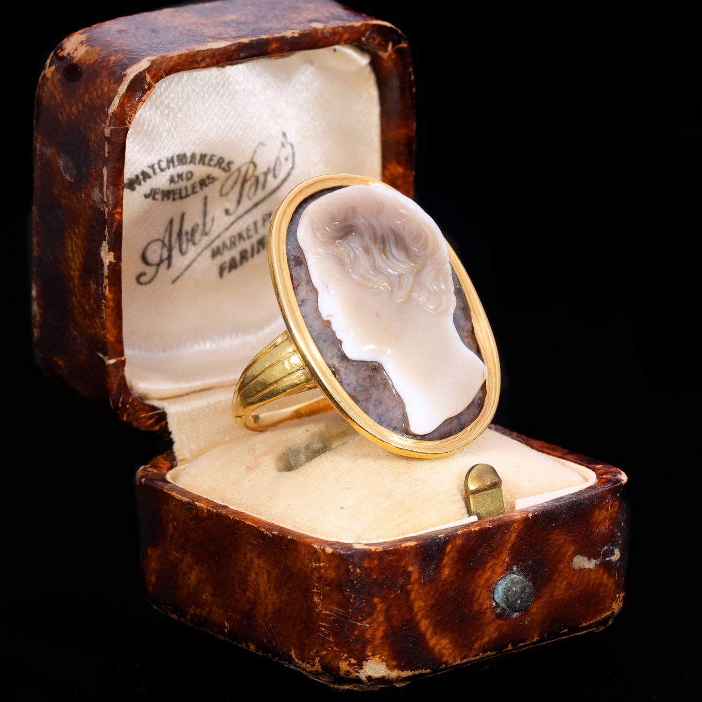 Sardonyx cameo depicting young man's profile in yellow gold oval setting