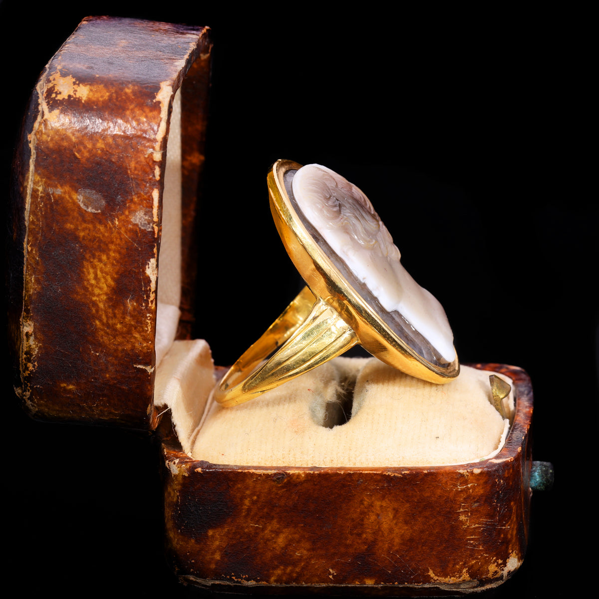 Side profile of large sardonyx cameo ring in yellow gold oval bezel setting