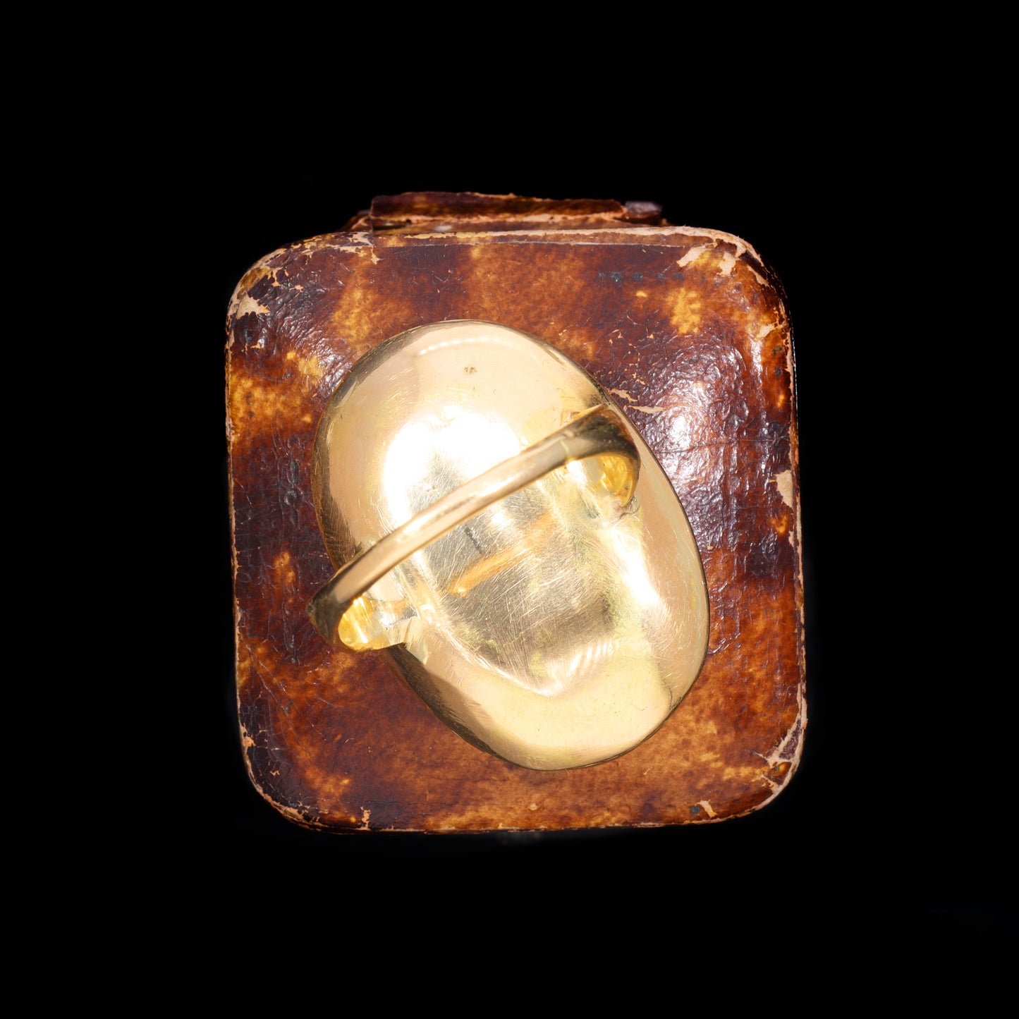 Reverse of gold setting showing pin-back mount and scratched base metal