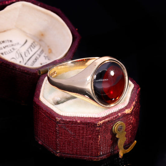 Three-quarter view of vintage 9ct gold garnet cabochon signet ring, 1979