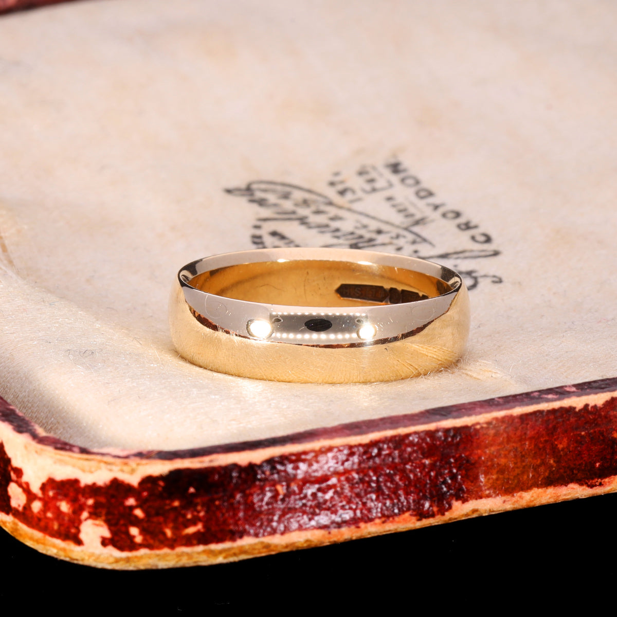 Three-quarter view of vintage 1966 9ct gold D-shape wedding band