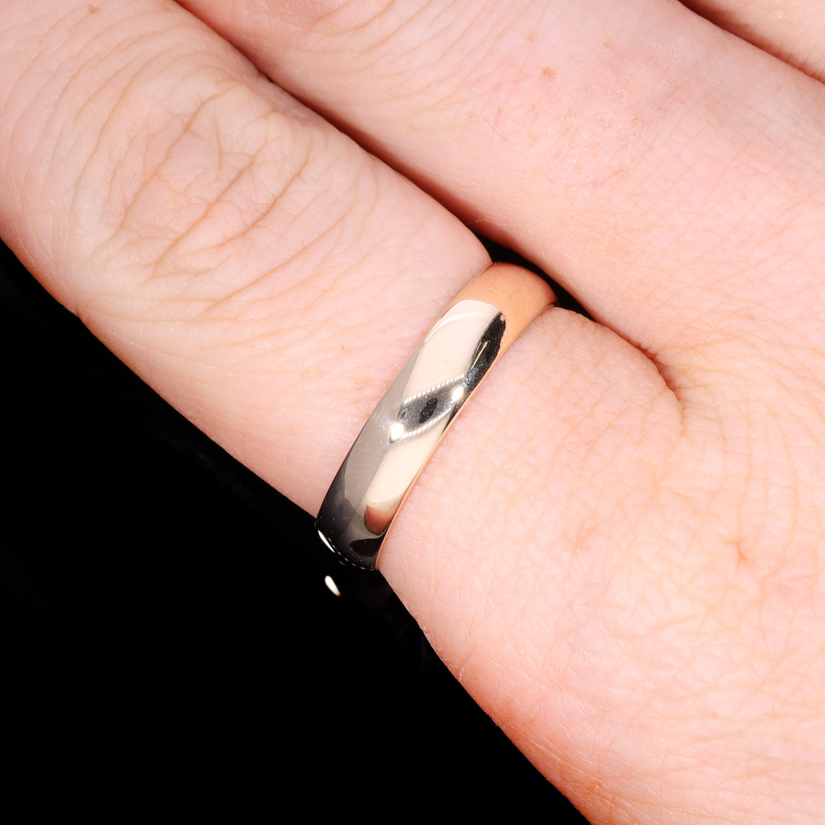 Ring worn on hand showing scale and high-polish D-shape profile