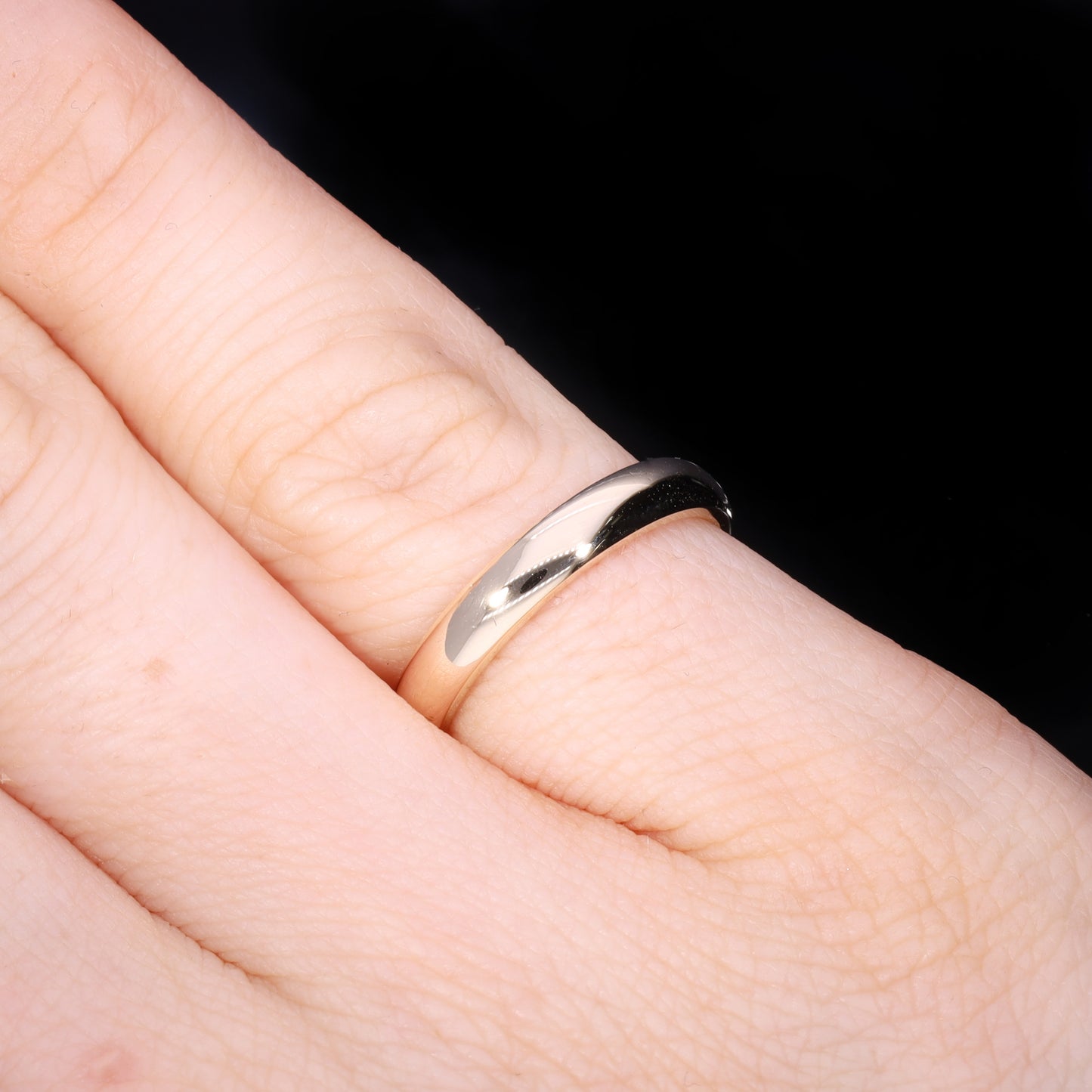 Ring worn on hand showing scale and court profile