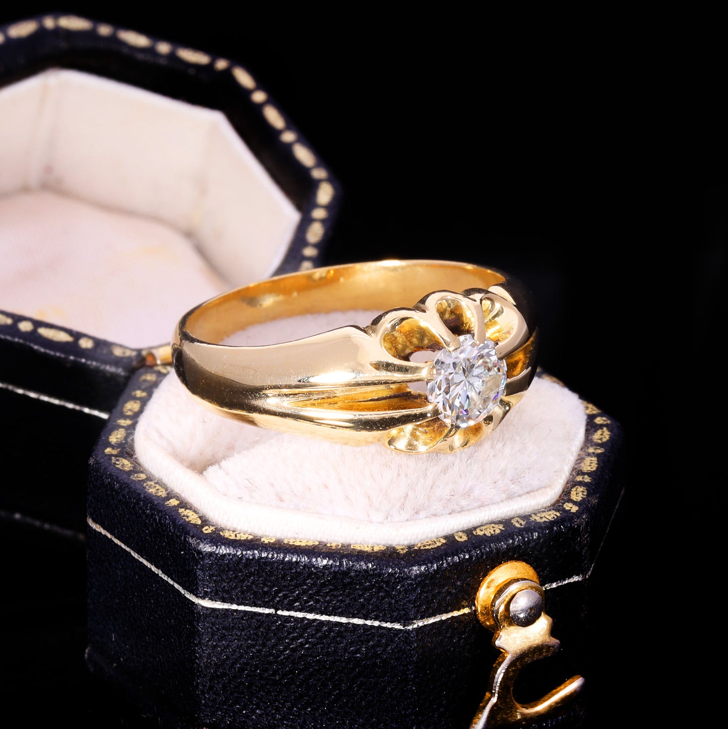 Three-quarter view of 18ct gold diamond solitaire in buttercup setting