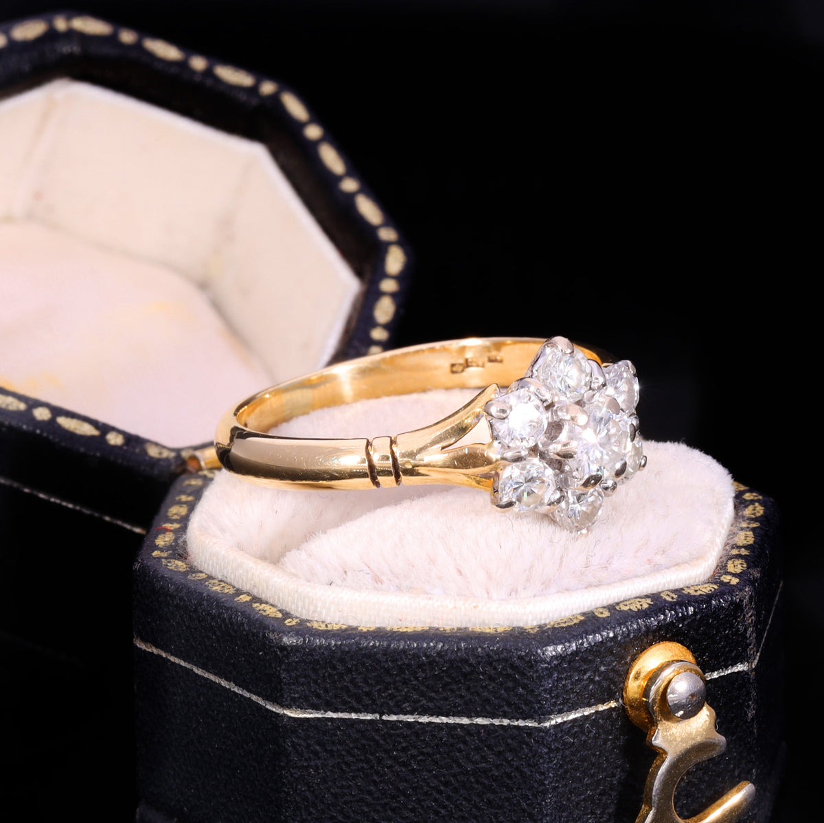 Three-quarter view of 1989 18ct gold diamond cluster ring with split shoulders
