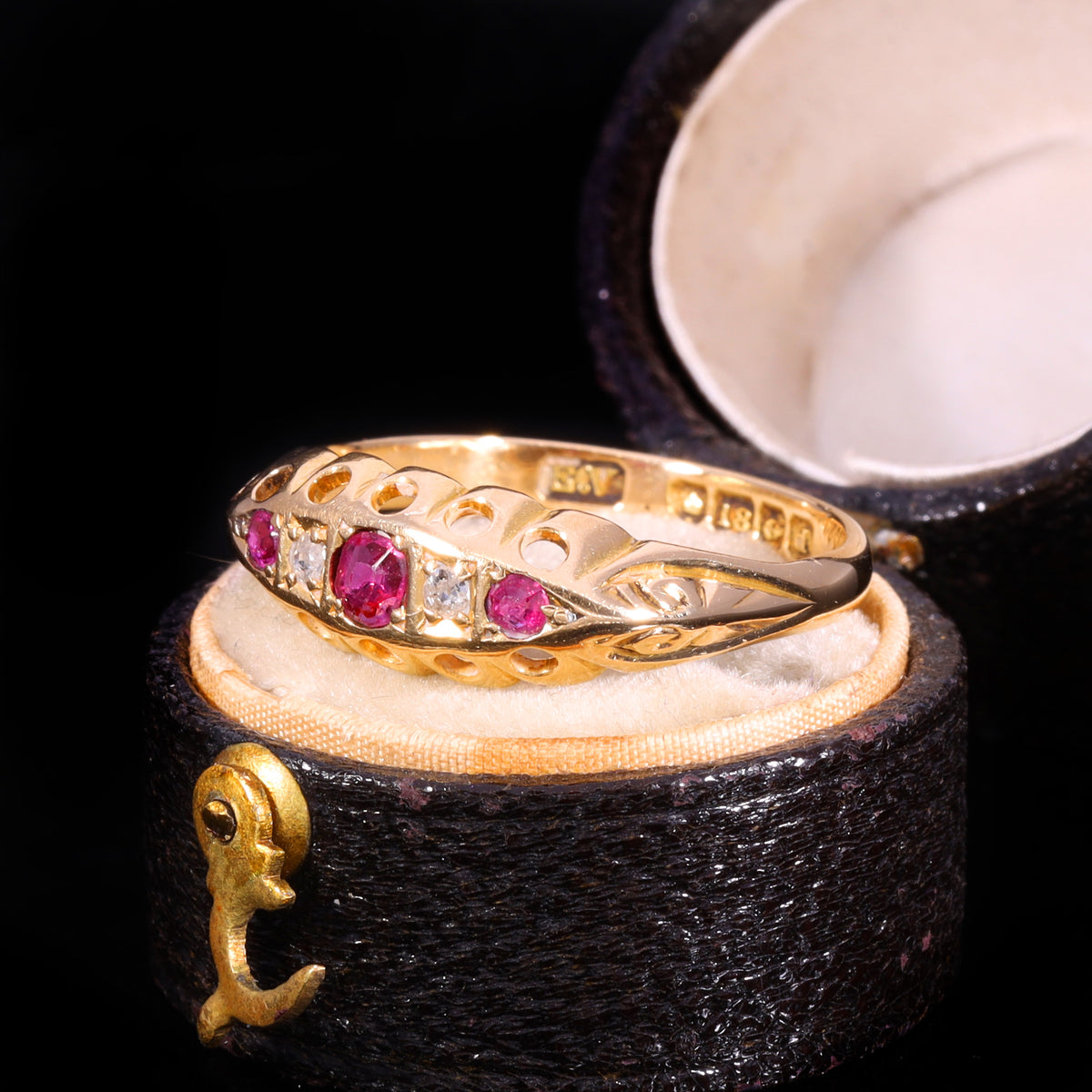 Three-quarter view of Edwardian 18ct gold ruby and diamond five-stone boat ring