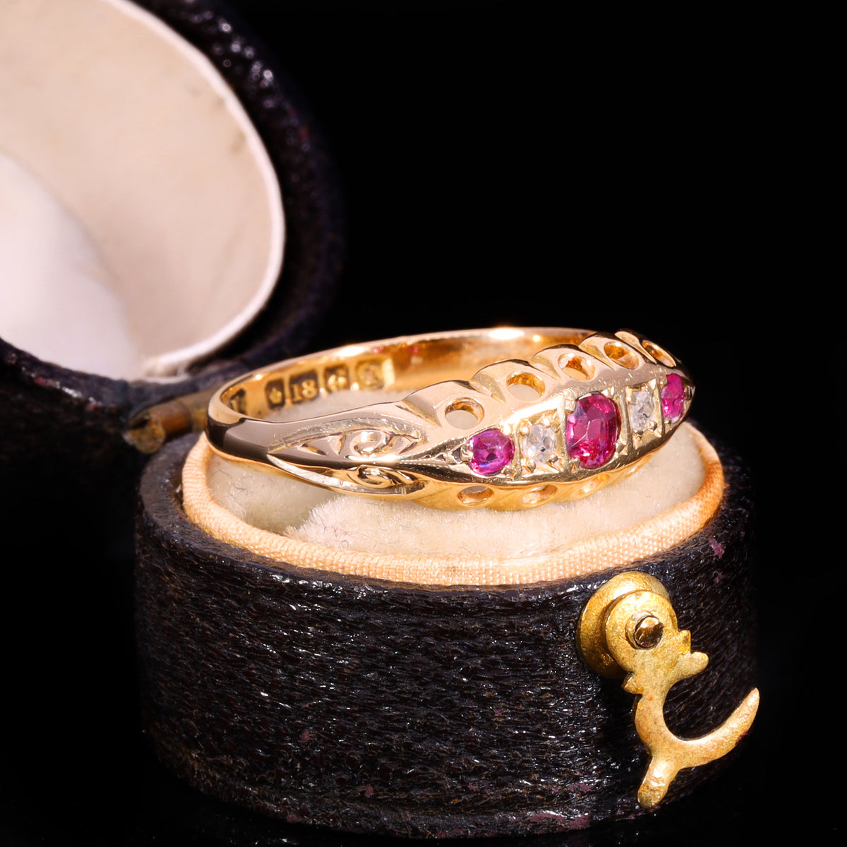 Three-quarter view of Edwardian 18ct gold ruby and diamond five-stone boat ring