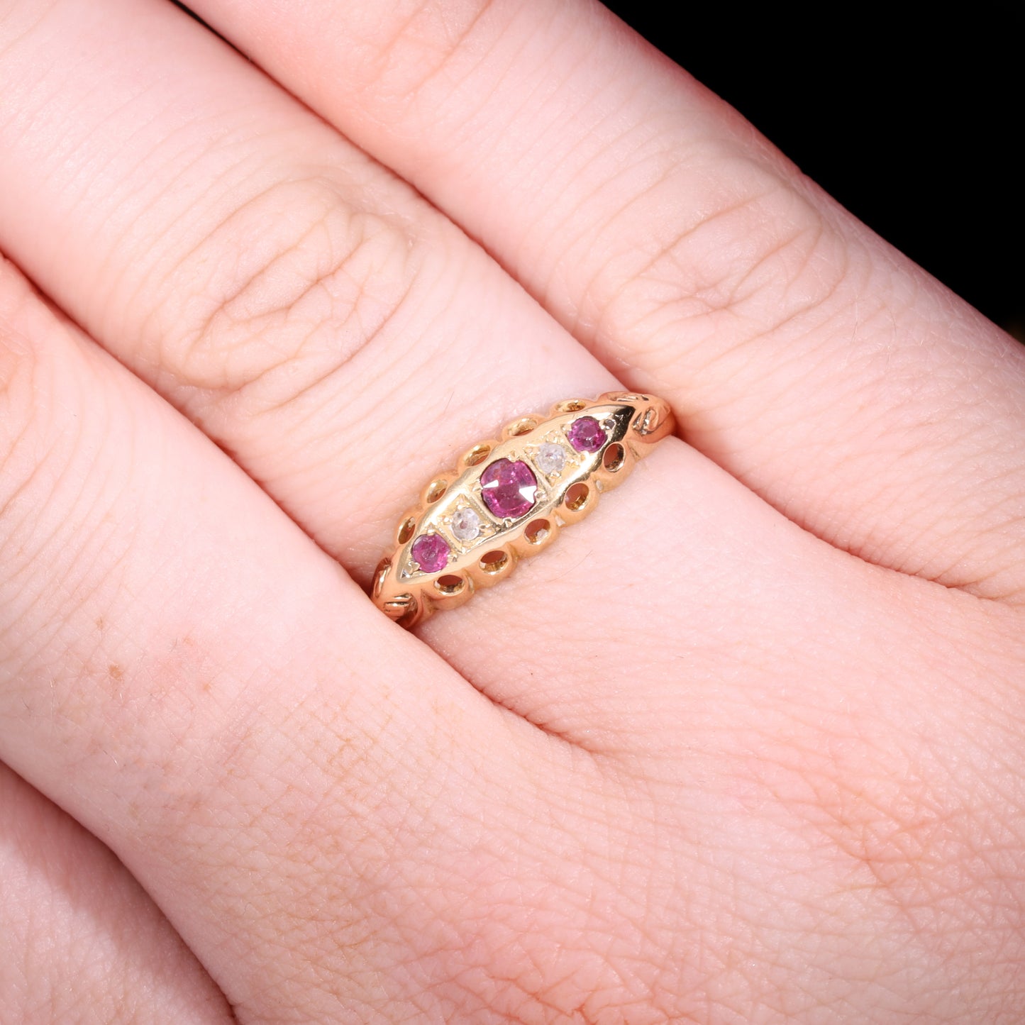 Ring worn on hand showing scale and boat-shaped ruby and diamond setting