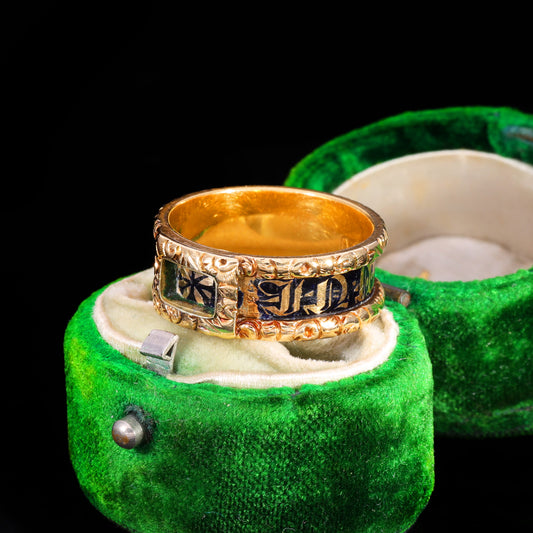 Three-quarter view of Victorian gold mourning band with black enamel lettering