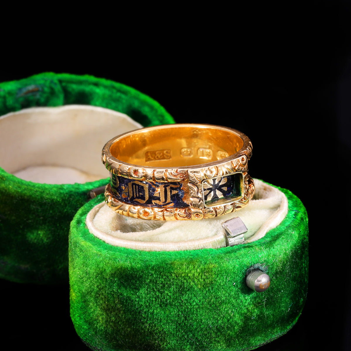Three-quarter view of Victorian gold mourning band with dark blue enamel and initials
