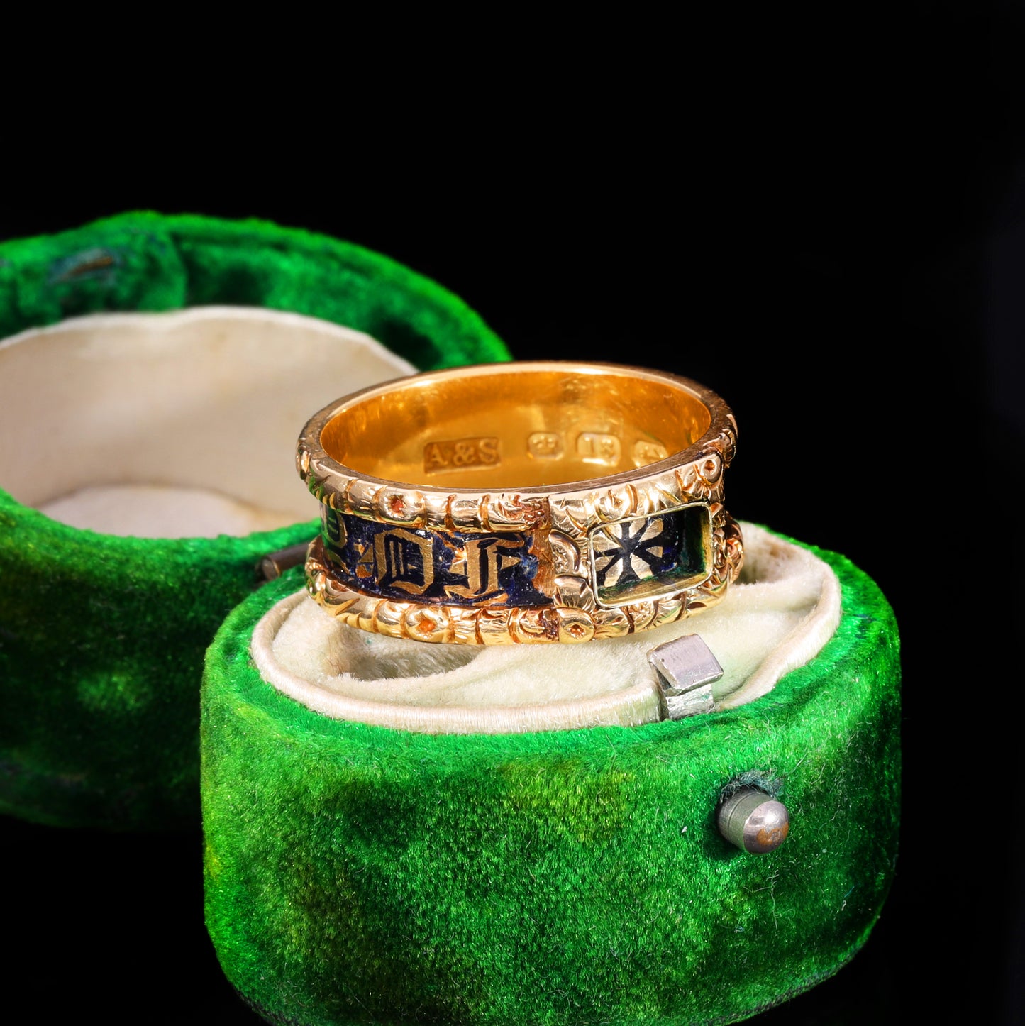 Three-quarter view of Victorian gold mourning band with dark blue enamel and initials