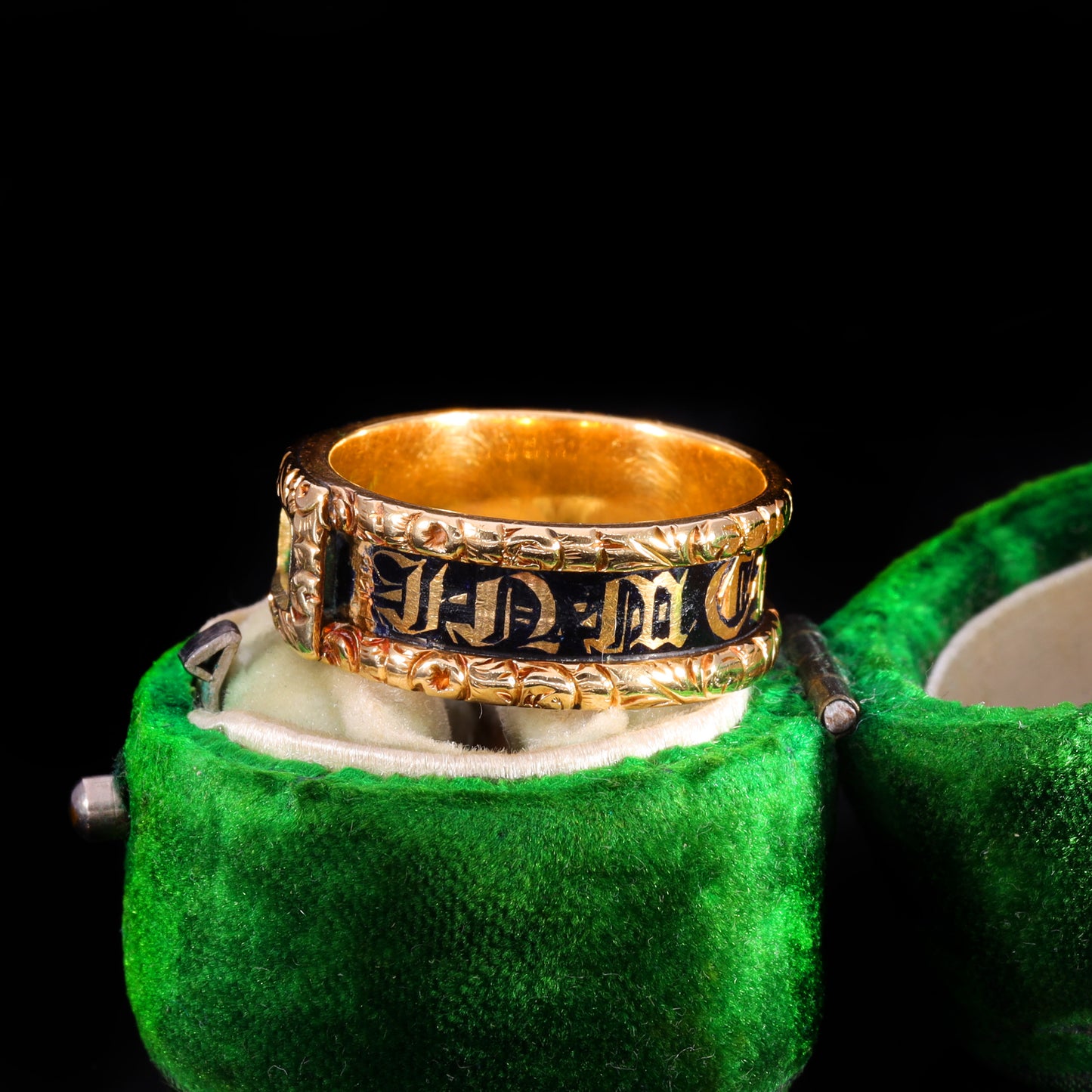 Three-quarter view of Victorian gold mourning band with black enamel inscription