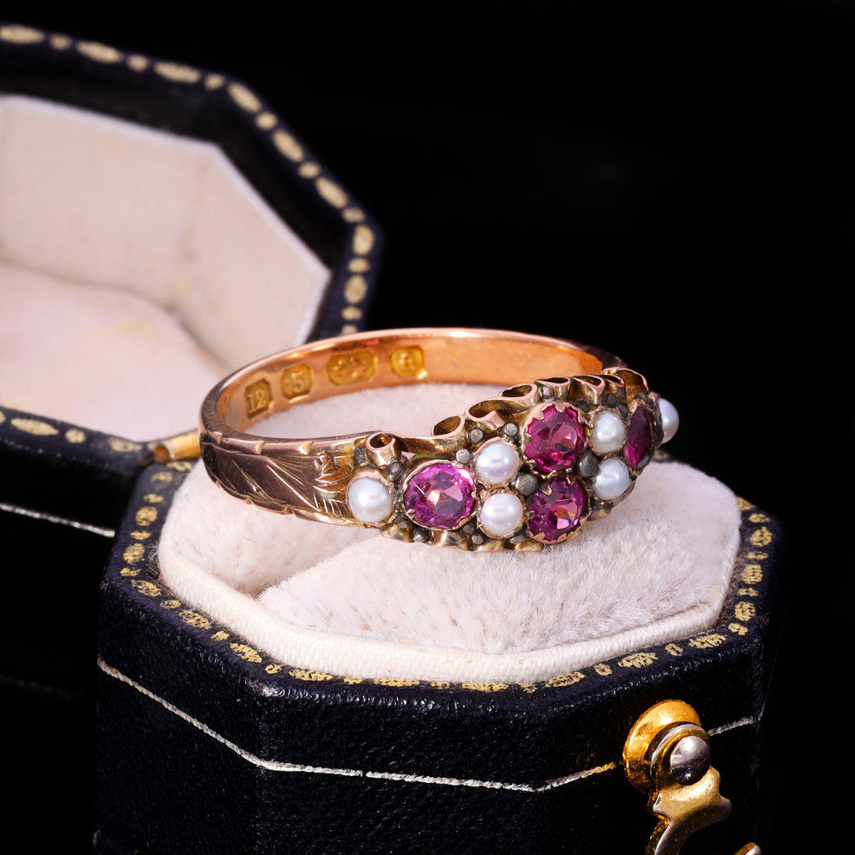 Three-quarter view of Victorian almandine garnet and seed pearl cluster ring
