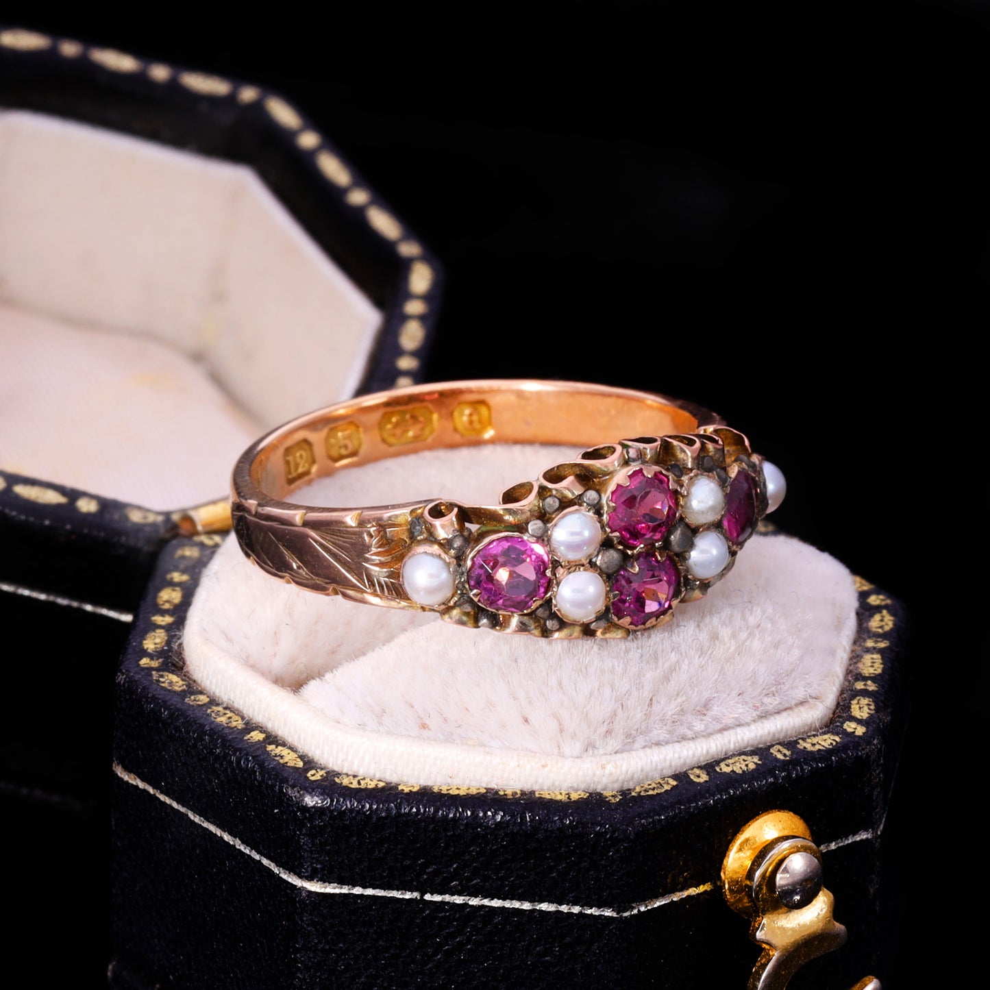 Three-quarter view of Victorian almandine garnet and seed pearl cluster ring