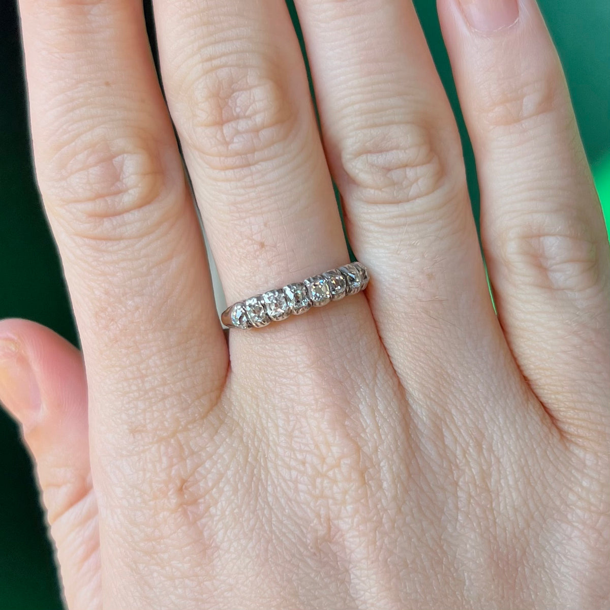 Ring worn on hand showing scale of Victorian diamond half hoop band