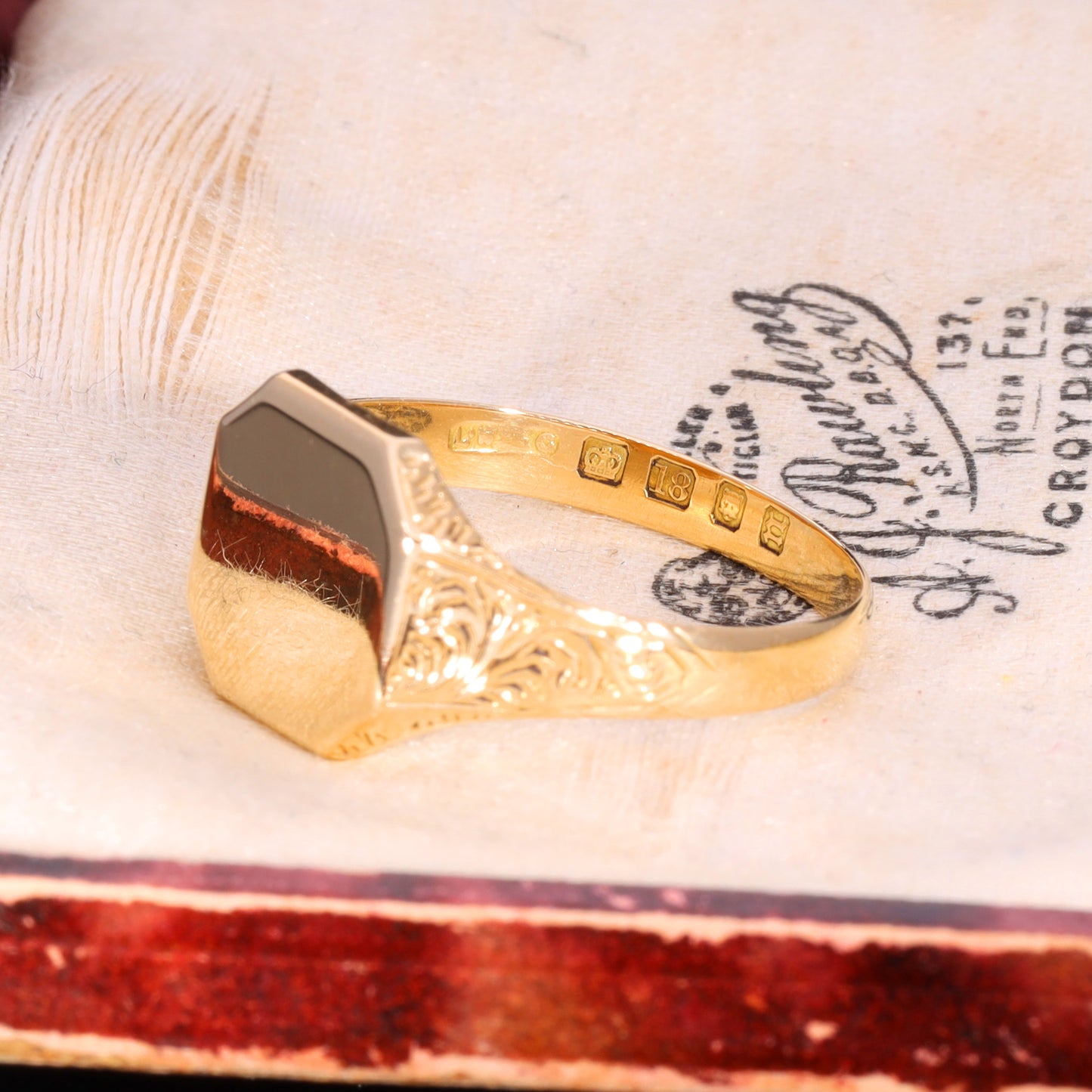 Side profile showing foliate engraved shoulders and London 1868 hallmarks on inner band